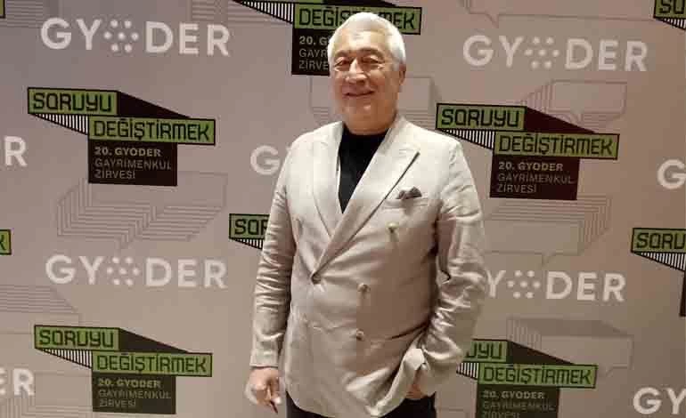 GYODER 20. Gayrimenkul Zirvesi fonu önünde duran Bilge Özdemir