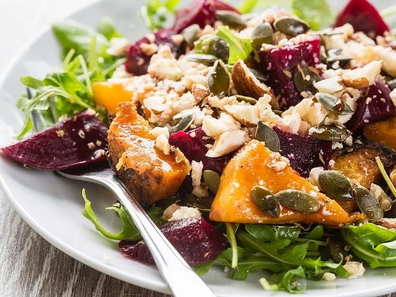 Fırınlanmış bal kabağı ve pancar, roka, peynir ve kıtır malzemelerle salata olarak sunulmuş